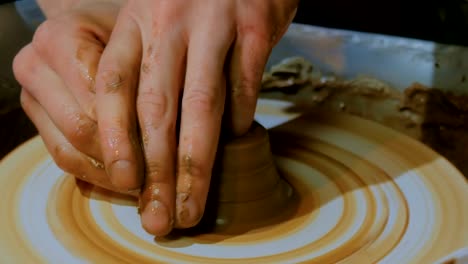 Professional-male-potter-working-in-workshop