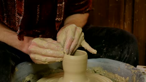 Professional-male-potter-working-in-workshop