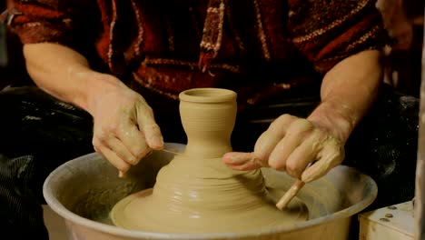 Professional-male-potter-working-in-workshop,-studio