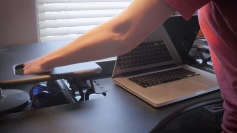 Woman-Changes-the-Height-on-a-Variable-Standing-Desk