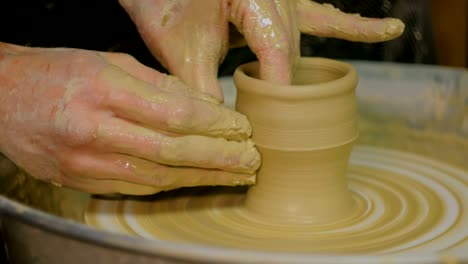 Professional-male-potter-working-in-workshop