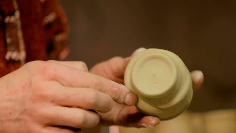 Professional-male-potter-working-in-workshop