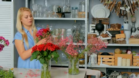 Professional-florist-making-beautiful-bouquet-at-flower-store