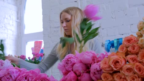 Professional-floral-artist-sorting-flowers-at-studio