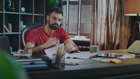 Young-business-man-signing-documents-in-office.-Man-signing-papers-at-workplace