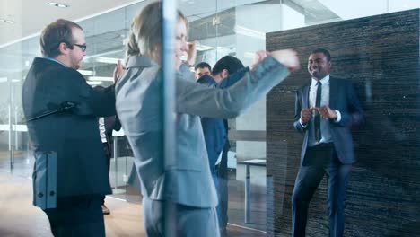 Diverse-Group-of-Business-People-Celebrate-Closing-of-the-Deal-and-Dance.-Funny-and-Friendly-Theme.