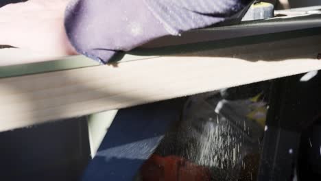 Close-Up-Of-Carpenter-Sawing-Timber-Indoors