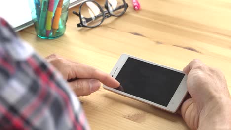 Businessman-in-Black-Scott-Shirt-Slide-Zoom-Touch-Horizontal-Smartphone-in-Home-Office