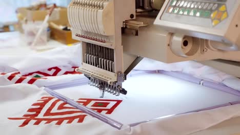 Young-man-making-ornament-on-computerized-embroidery-machine