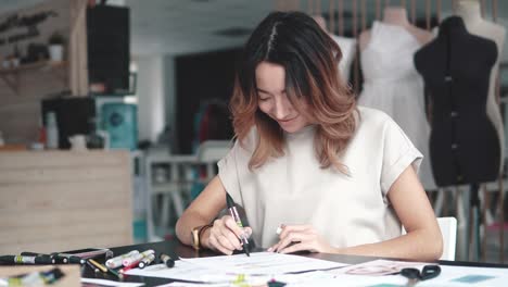 designer-of-clothes-makes-a-sketch-of-clothes-in-a-sewing-workshop.-a-girl-working-for-herself-is-busy-with-creative-work