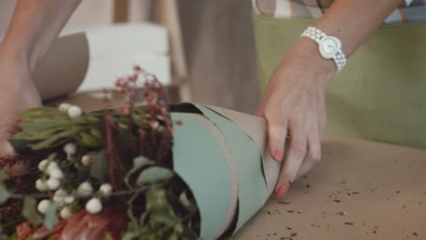 Florist-packing-festive-bouquet-in-wrapping-paper