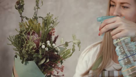 Florist-watering-flower-bouquet-arrangement