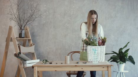 Florist-laying-out-flowers-and-plants-at-workplace