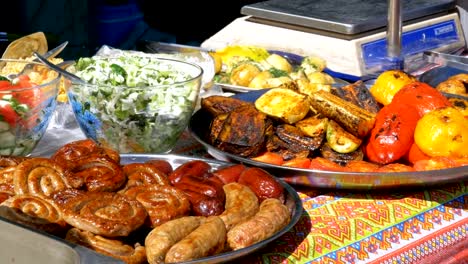 Top-view-on-Various-sausages,-vegetables,-Bulgarian-pepper-and-other-food-cooked-on-the-grill