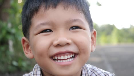 Close-up-little-boy-laughing-and-smile-after-hearing-joke-story