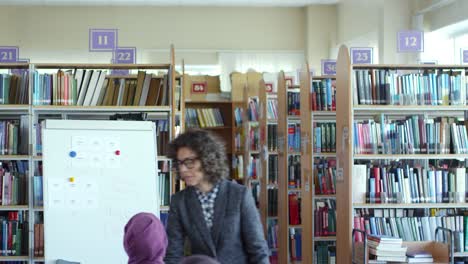 Young-Female-Lecturer-Talking-to-Refugee-Students