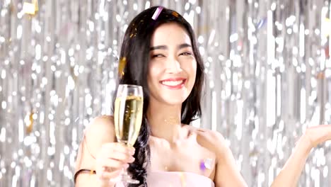 Asian-woman-carrying-champagne-with-attractive-smile-at-party-event.-People-with-party,-celebration,-new-year-concept.