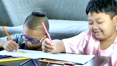 Boys-with-disability,-brain-disorders-And-Left-eye-is-not-visible-from-brain-surgery.-Have-fun,-enjoy-drawing-or-write-in-book-with-friends-at-home.