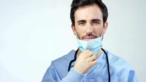 close-up-portrait-of-a-surgeon-or-doctor-with-mask-and-headset-ready-for-operation-in-hospital-or-clinic.-The-surgeon-smiles-safe-and-proud-of-himself.