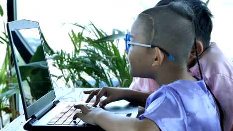 Happy-little-asian-boy-two-people-with-computer-laptop.