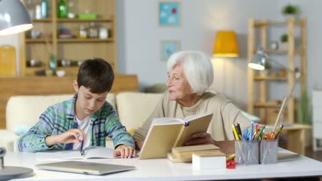 Senior-Woman-Doing-Homework-with-Grandson