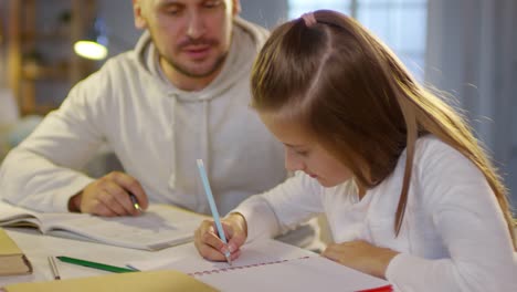 Dad-and-Daughter-Doing-Homework-in-the-Evening