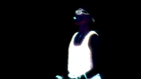 Woman-with-UV-face-paint,-glowing-clothing,-glowing-glasses,-bracelet-dancing-in-front-of-camera,-half-body-shot.-Asian-woman.-Glitch-effect.-Women.