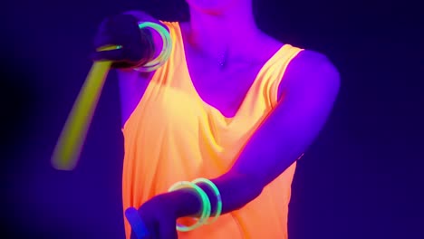 Slow-motin-of-beautiful-sexy-women-with-fluorescent-make-up-and-clothing-dancing-in-neon-light.-Night-club,-Party-Concept.