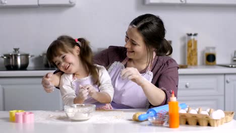 Family-with-special-needs-kid-preparing-bakery