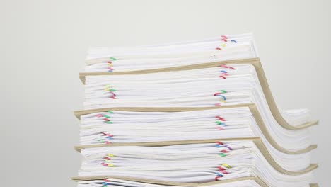 Overload-stack-paperwork-and-envelope-on-white-table-time-lapse