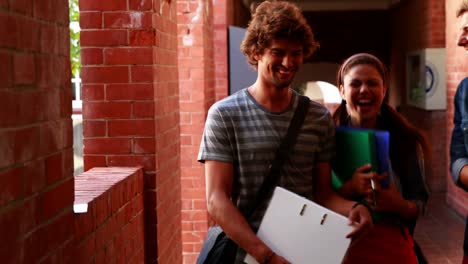 Students-walking-along-the-hallway-chatting