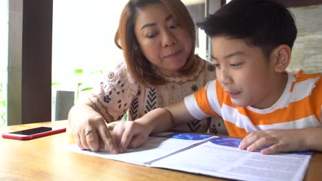 Happy-asian-family-boy-and-parent-reading-together