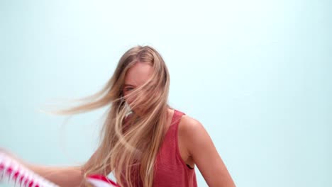 Very-cool-young-woman-gooving-around-with-inflatable-guitar