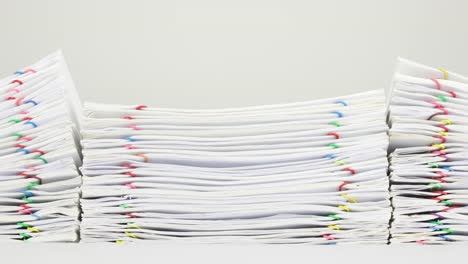 Pile-overload-paperwork-of-report-on-white-background-time-lapse