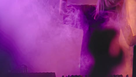 Female-DJ-Playing-Set-in-Smoky-Club