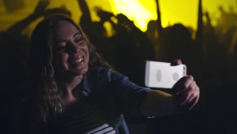 Girl-dancing-and-filming-herself-at-concert