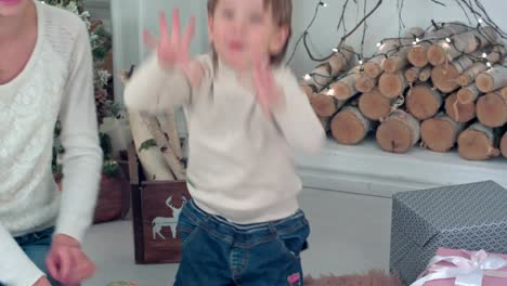 Young-mother-and-excited-boy-counting-Christmas-presents-on-his-fingers