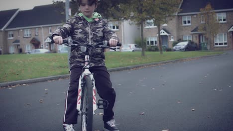 4k-Sport-Outdoor-Child-with-Bicycle-Stopping-and-Looking-at-his-Smartwatch
