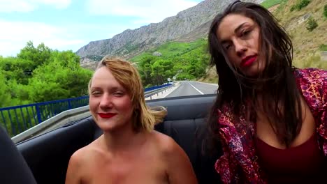 Two-happy-women-partying-in-cabriolet