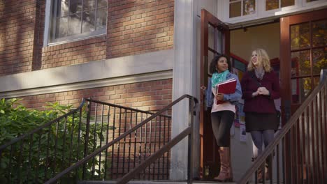 Two-college-students-walking-down-stairs