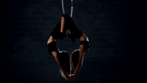 Two-beautiful-gymnasts-performs-trick-at-the-aerial-hoop