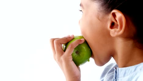 Cute-girl-having-green-apple-against-white-background