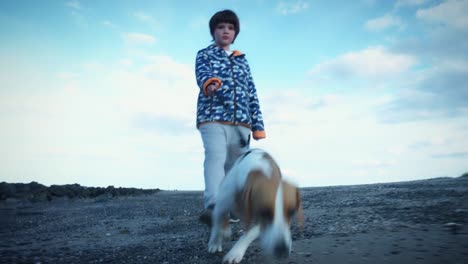 4K-Outdoor-Seaside-Child-and-Dog-Walking-to-Camera