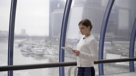 businesswoman-stay-opposite-window