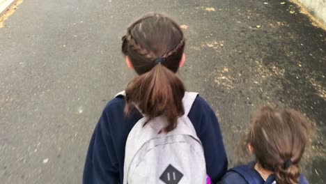 Two-sister-girls-walking-together-to-school