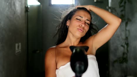 Woman-In-Bathroom-Singing-Drying-Hair-With-Blow-Dryer,-Lovely-Cheerful-Beautiful-Girl-In-Towel-Happy-Smiling