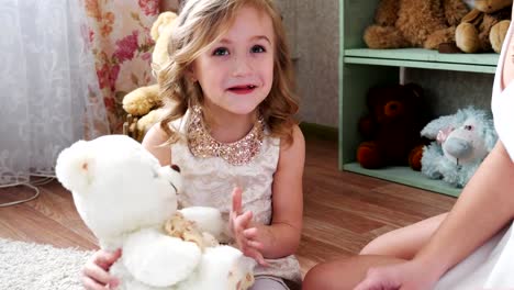 Mother-and-daughter-playing-with-a-teddy-bear,-having-fun-together,-4k