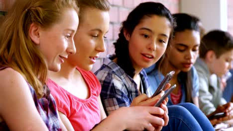 Group-of-school-friends-using-mobile-phone-4k