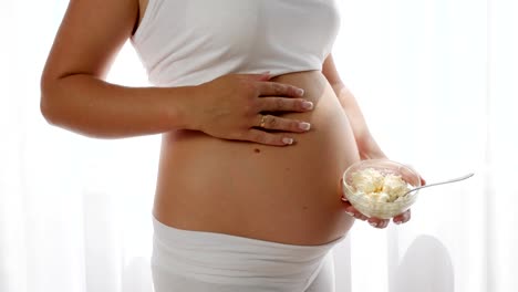 pregnancy,-sour-milk-products-in-hand-of-future-mother