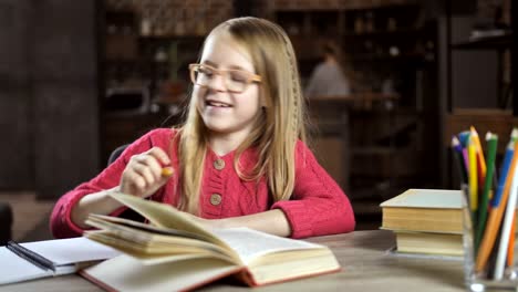 Cheerful-girl-writing-her-homework-for-school